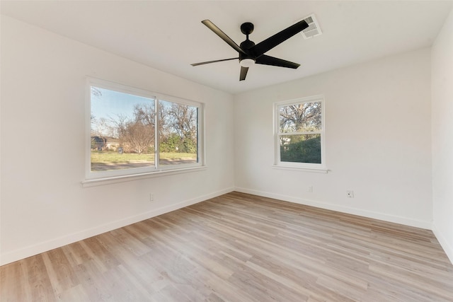 empty room featuring ceiling fan, visible vents, baseboards, and light wood-style flooring