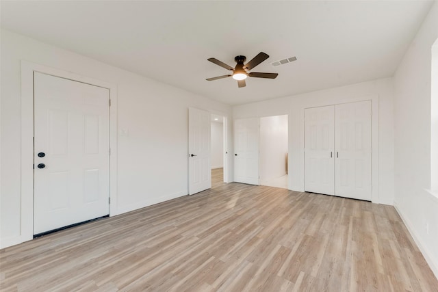 unfurnished bedroom with visible vents, baseboards, ceiling fan, light wood-style flooring, and a closet