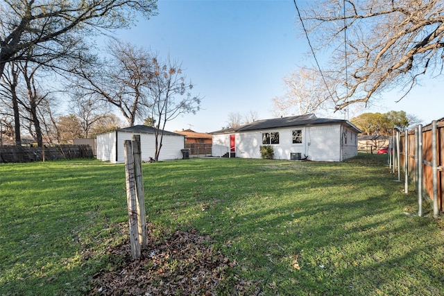 view of yard with an outdoor structure and a fenced backyard