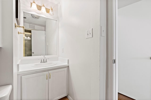 bathroom with toilet and vanity