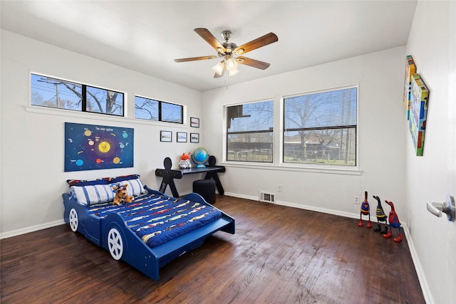 bedroom featuring visible vents, ceiling fan, baseboards, and wood-type flooring