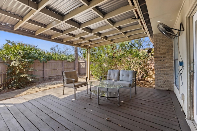 wooden terrace featuring an outdoor living space and fence