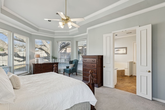 carpeted bedroom featuring a raised ceiling, ceiling fan, and crown molding