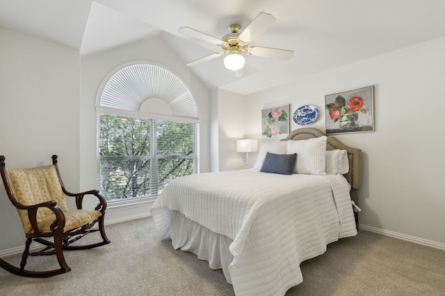 bedroom featuring baseboards, lofted ceiling, and carpet