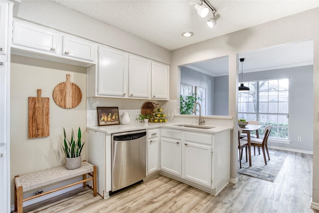 kitchen featuring a sink, white cabinetry, stainless steel dishwasher, and light countertops