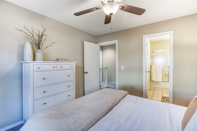 bedroom with connected bathroom, baseboards, a textured ceiling, and a ceiling fan