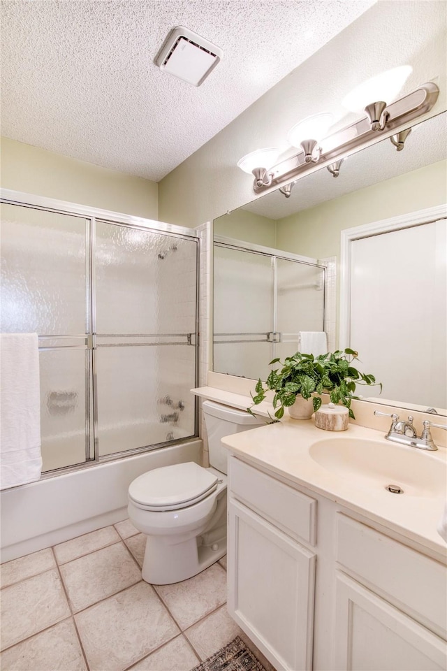 bathroom with visible vents, toilet, a textured ceiling, shower / bath combination with glass door, and vanity