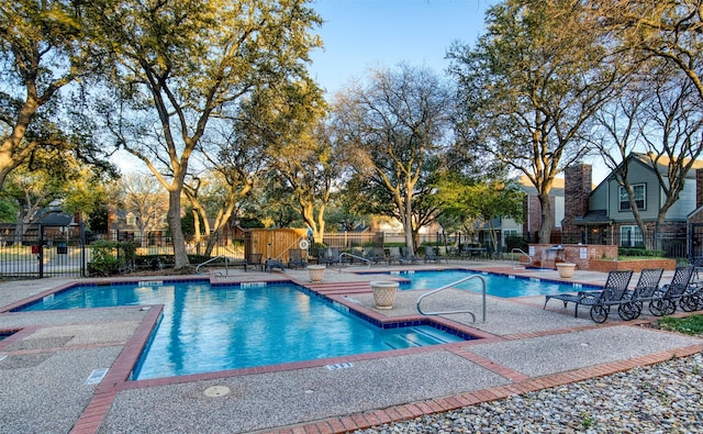 pool featuring a patio area and fence