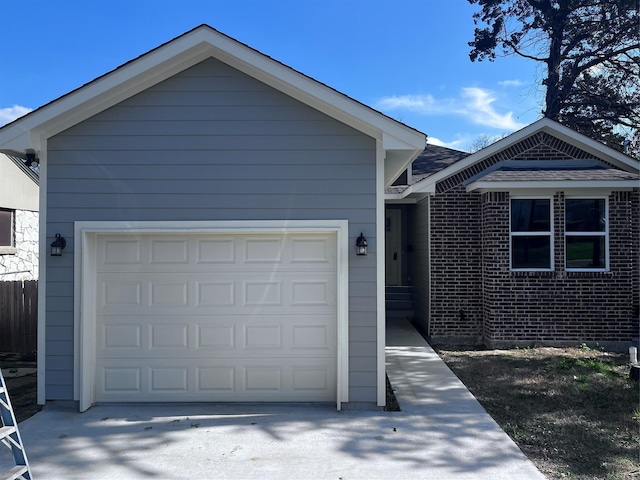 view of front of property with concrete driveway and an attached garage