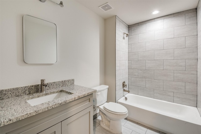 bathroom featuring tile patterned flooring, visible vents, shower / washtub combination, toilet, and vanity