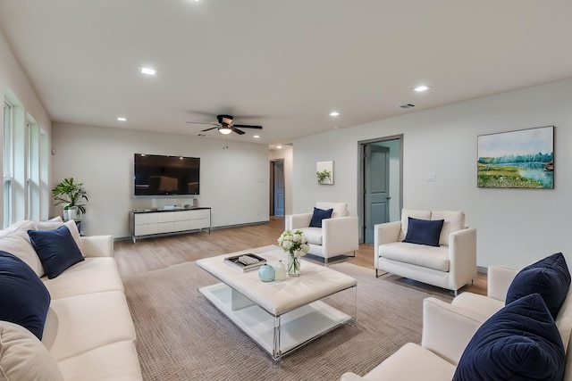 living room with recessed lighting, light wood-type flooring, visible vents, and a ceiling fan