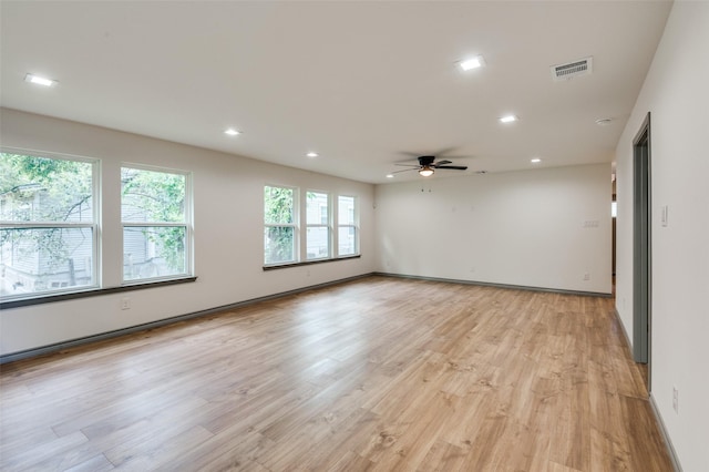 spare room with light wood-type flooring, visible vents, a ceiling fan, recessed lighting, and baseboards