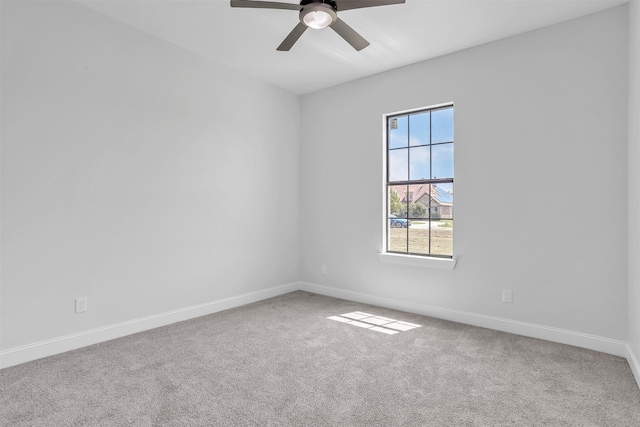 unfurnished room featuring baseboards, carpet floors, and a ceiling fan