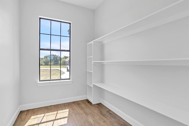 interior space featuring wood finished floors and baseboards