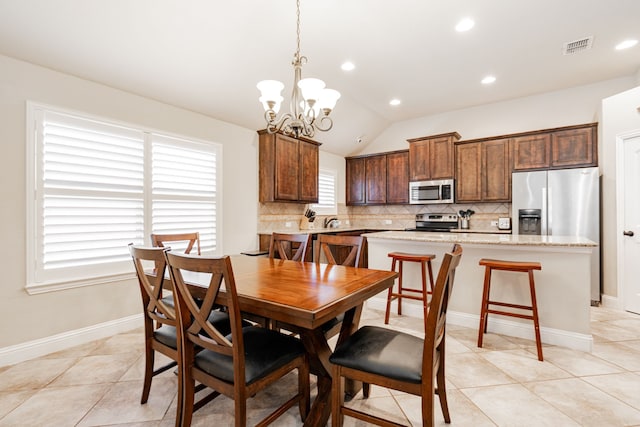 dining space featuring visible vents, an inviting chandelier, light tile patterned floors, baseboards, and vaulted ceiling