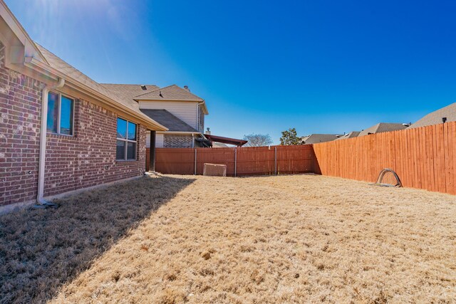 view of yard with a fenced backyard