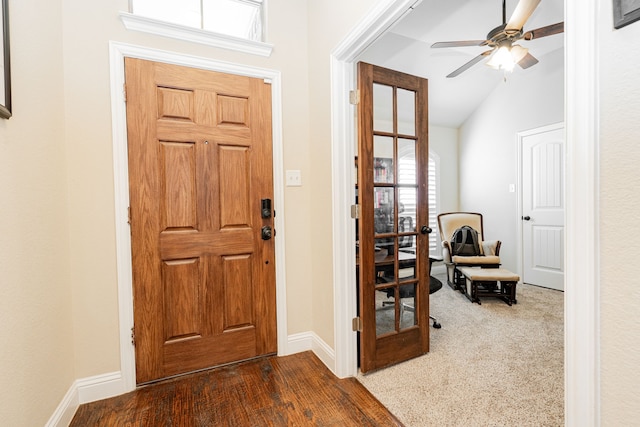 foyer with baseboards, lofted ceiling, dark wood-style floors, and a ceiling fan