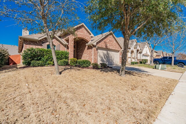 ranch-style home featuring concrete driveway, an attached garage, brick siding, and a chimney