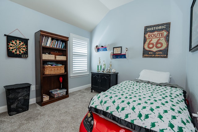 carpeted bedroom featuring lofted ceiling and baseboards