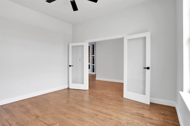 unfurnished room featuring a ceiling fan, french doors, baseboards, and light wood finished floors