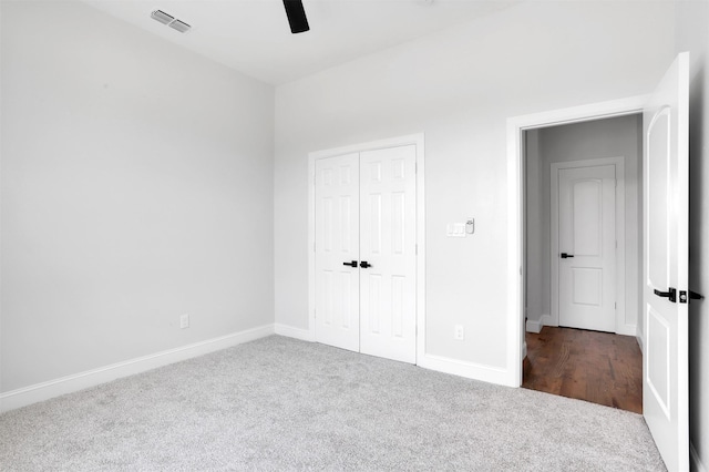 unfurnished bedroom featuring a ceiling fan, baseboards, visible vents, a closet, and carpet flooring