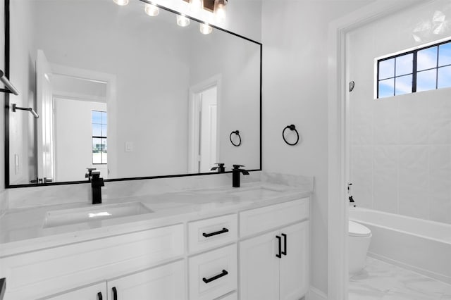 bathroom with marble finish floor, a wealth of natural light, and a sink