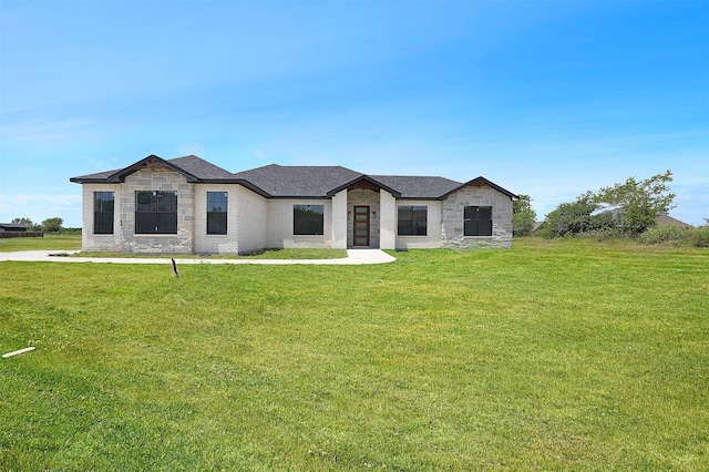 view of front of home featuring a front yard and brick siding