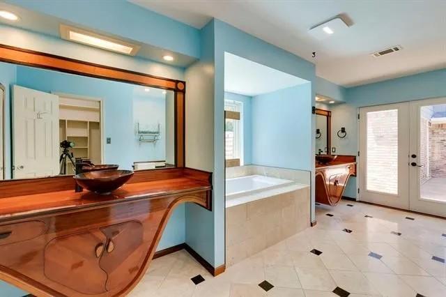 bathroom with vanity, visible vents, french doors, a garden tub, and tile patterned floors