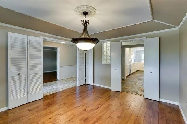 unfurnished dining area with baseboards and hardwood / wood-style floors