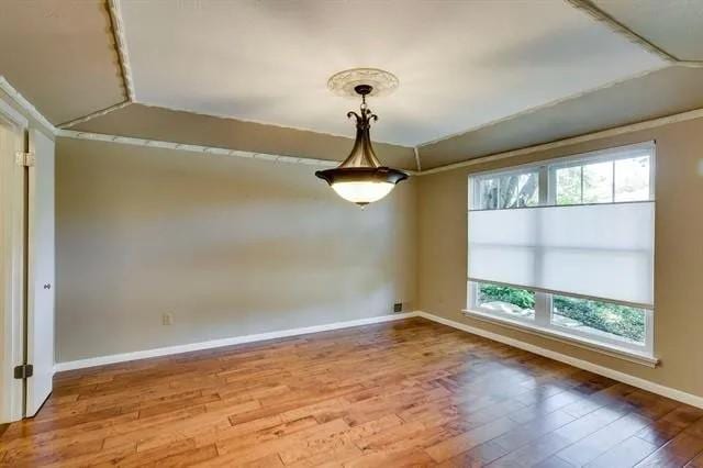 unfurnished room with wood finished floors and baseboards