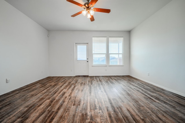 unfurnished room featuring dark wood-style floors, baseboards, and a ceiling fan