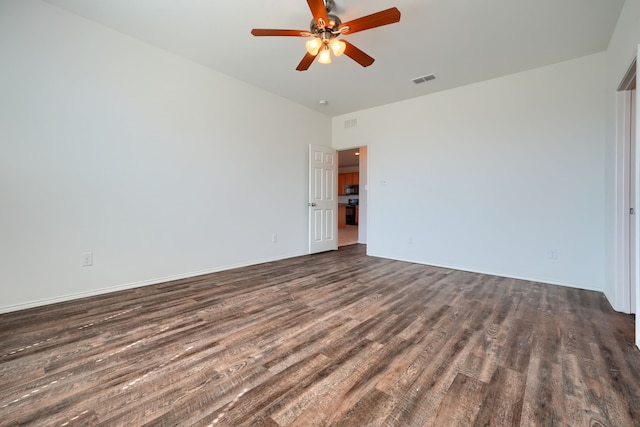 spare room featuring a ceiling fan, wood finished floors, and visible vents