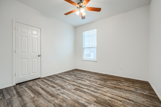 empty room featuring ceiling fan, baseboards, and wood finished floors