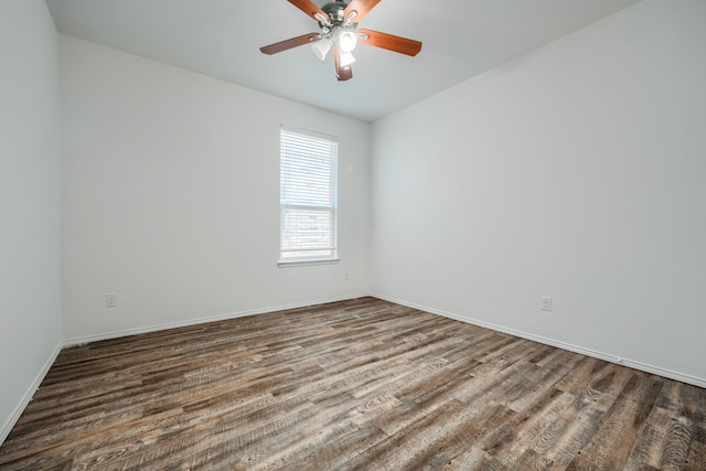 unfurnished room with ceiling fan, baseboards, and wood finished floors