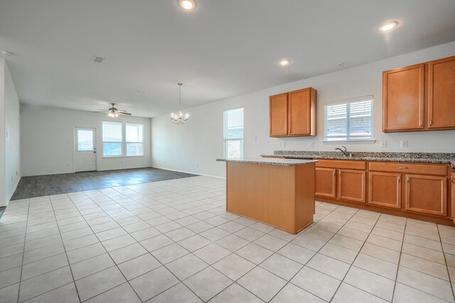 kitchen with visible vents, a kitchen island, and brown cabinetry