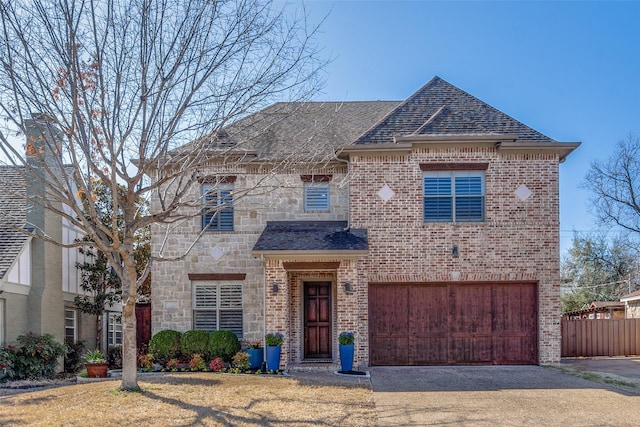 view of front of property featuring brick siding, a shingled roof, concrete driveway, a garage, and stone siding