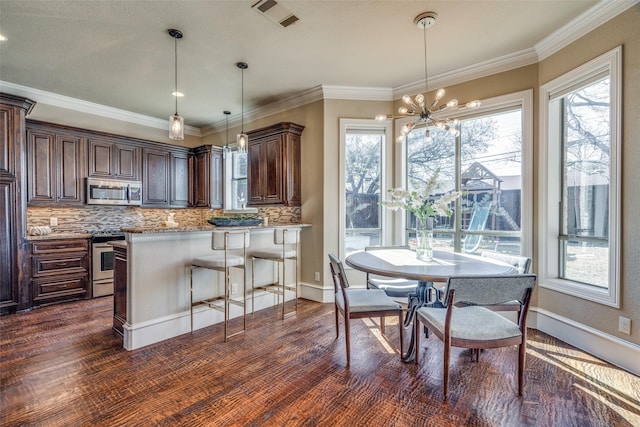 dining room with visible vents, dark wood-style floors, and ornamental molding