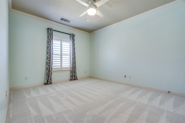 unfurnished room with crown molding, baseboards, visible vents, and carpet floors