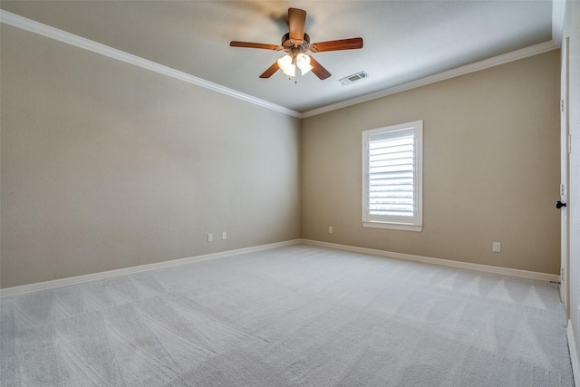 unfurnished room with visible vents, a ceiling fan, crown molding, baseboards, and light colored carpet