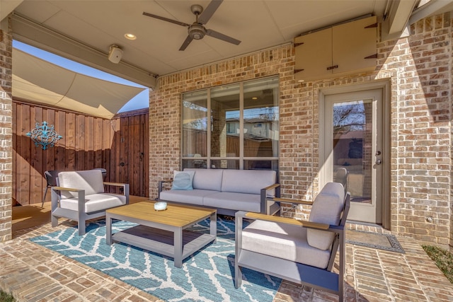 view of patio / terrace with outdoor lounge area, fence, and ceiling fan