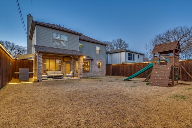 rear view of property with brick siding, central AC, and a fenced backyard