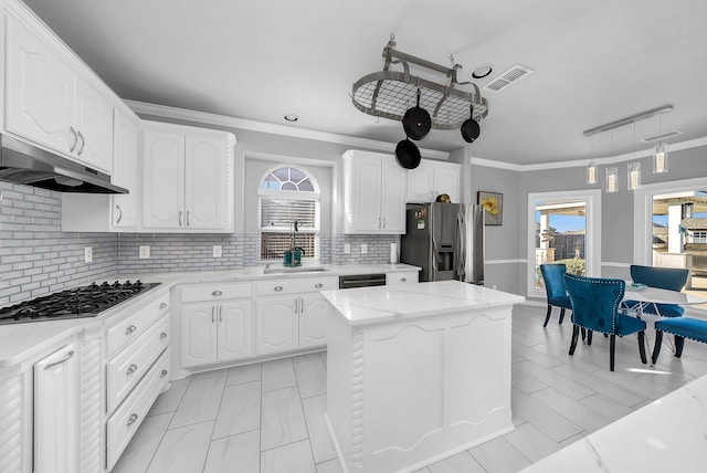 1416 Fence Post Dr, Fort Worth, TX 76052 - kitchen featuring stainless steel appliances, beverage cooler, arched walkways, white cabinetry, and crown molding