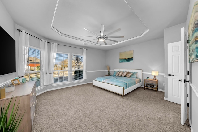 bedroom with light colored carpet, baseboards, and ceiling fan