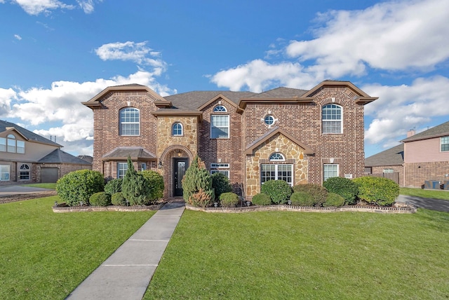 1416 Fence Post Dr, Fort Worth, TX 76052 - view of front of home featuring brick siding, a front yard, concrete driveway, and a garage