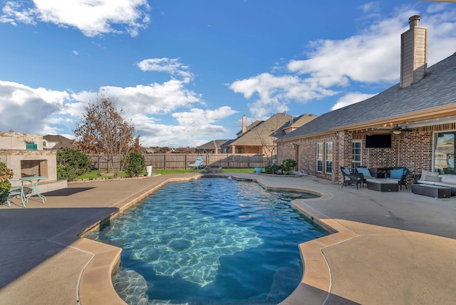 view of swimming pool with an outdoor living space, a fenced in pool, a fenced backyard, and a patio area