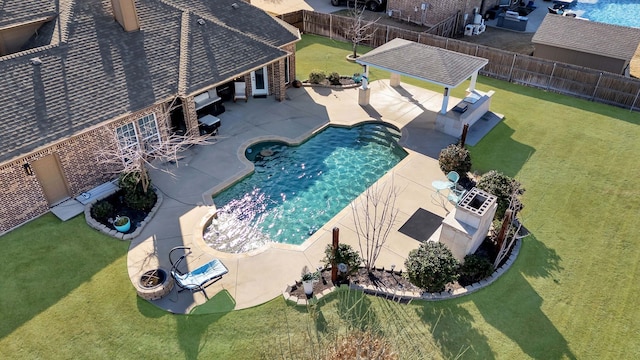 view of pool featuring a lawn, a fenced backyard, and a patio area