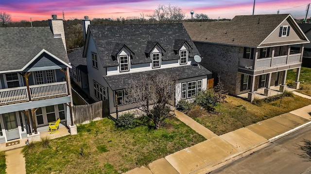 213 E 5th St, Ferris, TX 75125 - view of front of property featuring a balcony, fence, a chimney, and roof with shingles