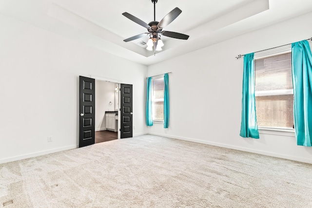 213 E 5th St, Ferris, TX 75125 - unfurnished bedroom with dark colored carpet, baseboards, a ceiling fan, and ensuite bathroom