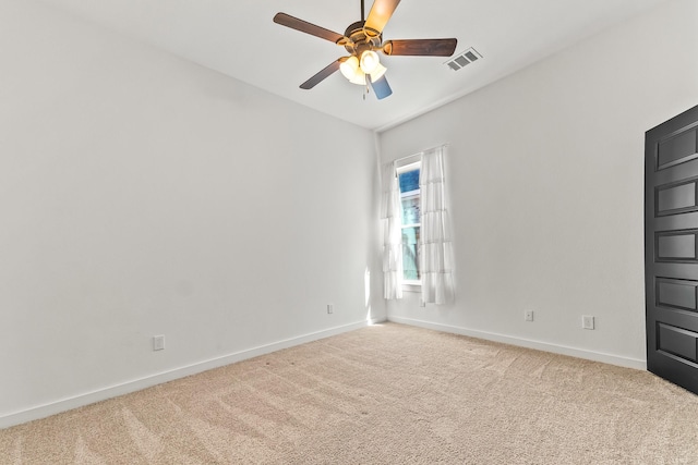 empty room featuring visible vents, baseboards, carpet, and ceiling fan