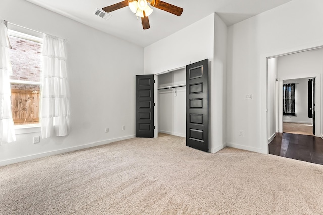 unfurnished bedroom with carpet, visible vents, a closet, and baseboards